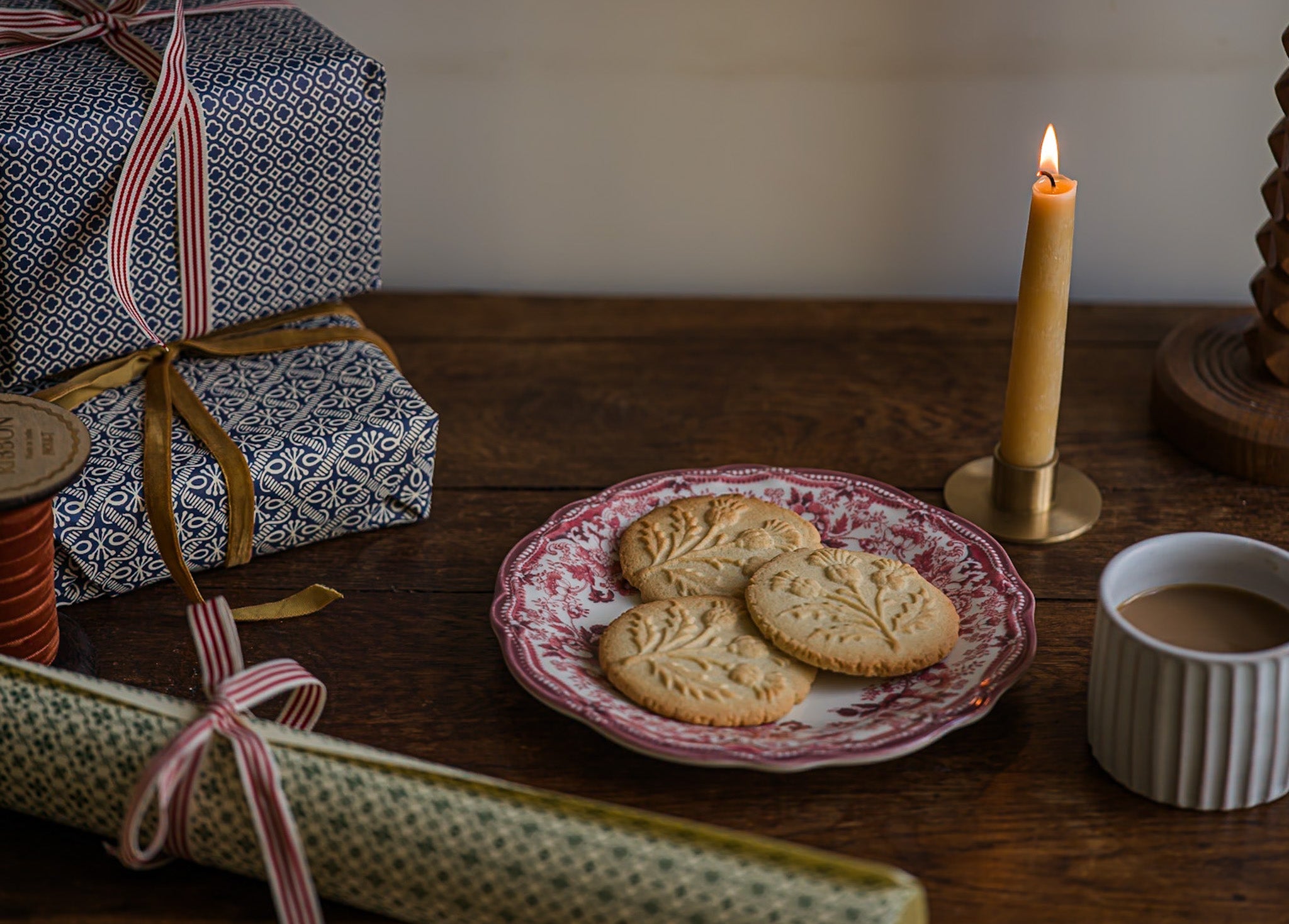 three classic sugar cookies stamped with an impression of a thistle