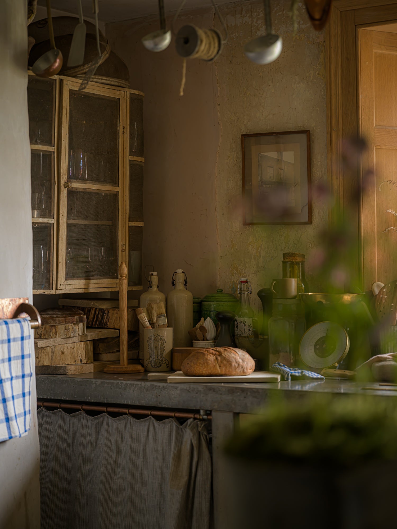 Vintage kitchen with rustic decor, including a loaf of bread on a counter.
